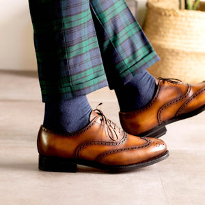 Lookbook Man wearing green and blue  check window pane trousers, blue socks,  and Cognac Calf Leather Goodyear Welted with leather and rubber sole Wingtip Oxford Brogue Dress Shoes