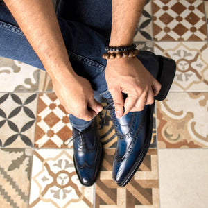 Look-book Man in Blue Jeans wearing Denim Blue Hand painted Patina Calf Crust Leather Goodyear Welted Wingtip Oxford Brogue Dress Shoes. Tying Laces